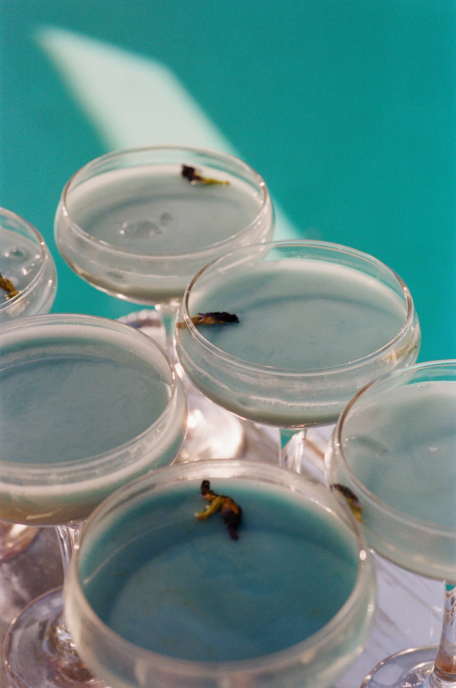Pale-blue signature cocktails poolside at a Caster House event, a private event venue in Los Angeles